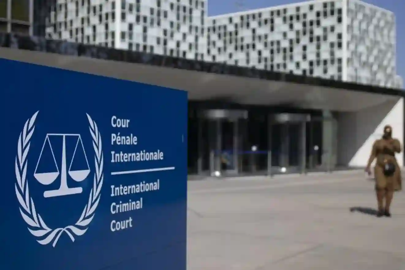 International Criminal Court building exterior with flags, symbolizing justice and global cooperation.