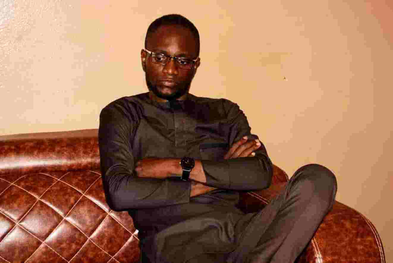 HoseÌe Houngnibo, Coordinator of networks, Olivier Boko, standing confidently in a professional setting.