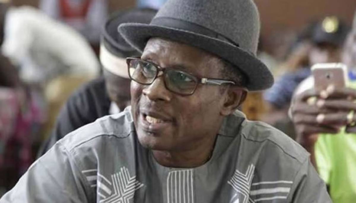 Laurent Mètongnon, former union leader, sitting in a prison cell.