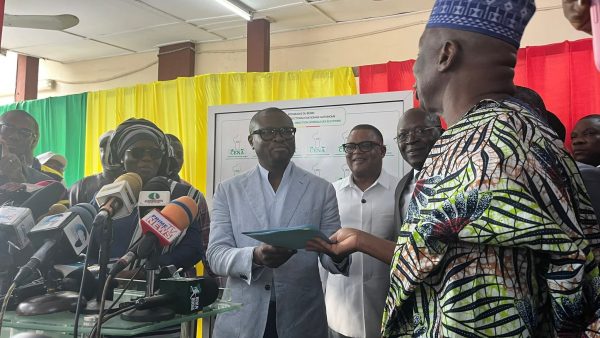 Romuald Wadagni holding his candidacy submission receipt for the 2026 presidential election in Benin.