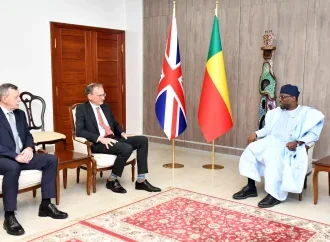 New UK ambassador to Benin presenting credentials in a formal setting.