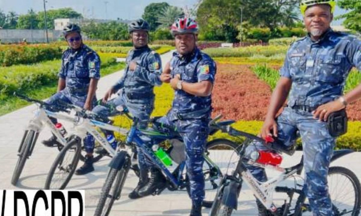 Police officers conducting bicycle patrols in Cotonou's 5th arrondissement for enhanced security.