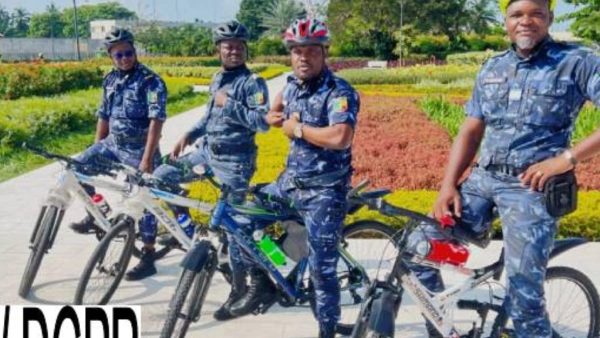 Police officers conducting bicycle patrols in Cotonou's 5th arrondissement for enhanced security.