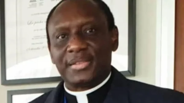 Mgr Éric Soviguidi, a cleric in formal attire, preparing for his ordination ceremony.