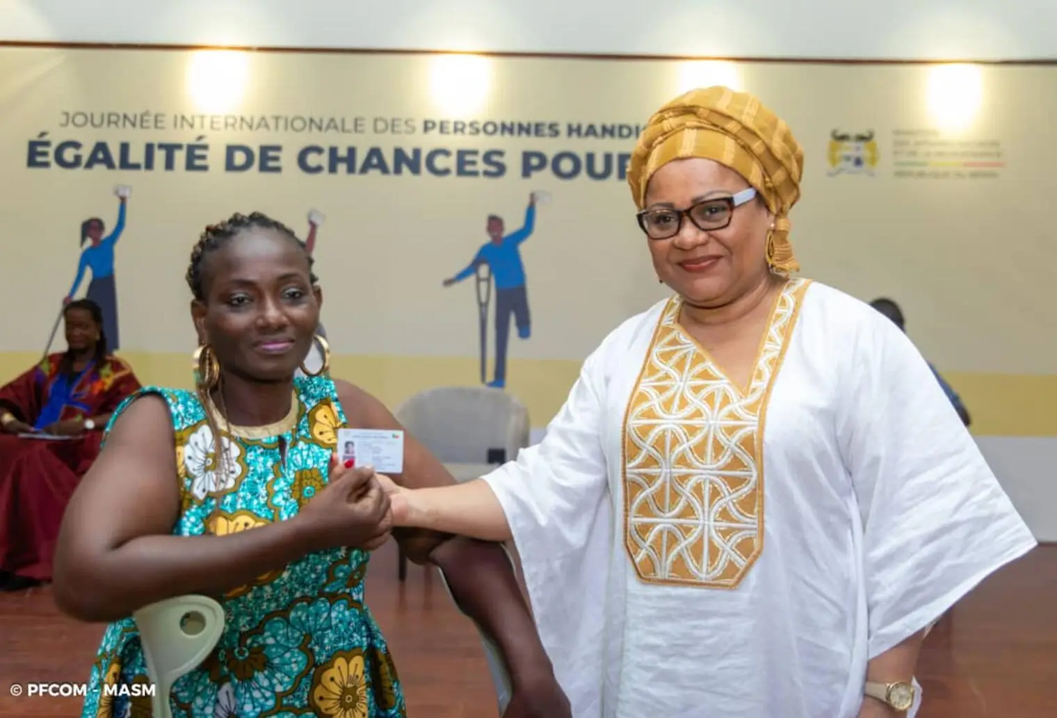 Veronique Tognifodé aux côtés d'une personne en situation de handicap lors d'une remise de carte d'égalité des chances.