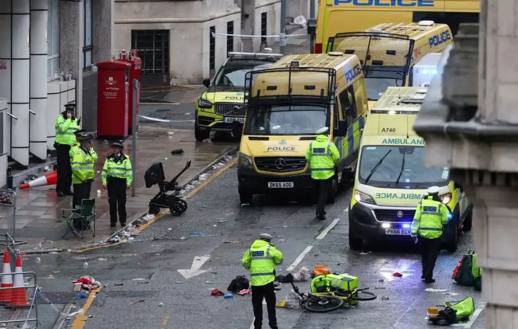 Police officers investigate the scene of an incident in Water Street, on the sidelines of an open-top bus victory parade for Liverpool's Premier League title win, in Liverpool, north-west England on May 26, 2025. (Photo by Darren Staples / AFP) - D. Staples/AFP