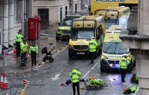 Police officers investigate the scene of an incident in Water Street, on the sidelines of an open-top bus victory parade for Liverpool's Premier League title win, in Liverpool, north-west England on May 26, 2025. (Photo by Darren Staples / AFP) - D. Staples/AFP