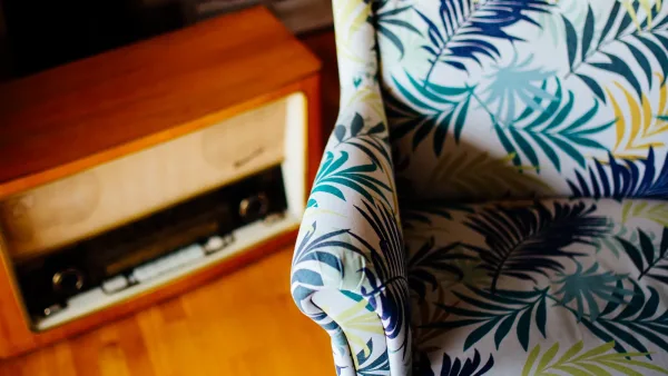 Salon chaleureux mêlant fauteuil coloré et meuble vintage en bois